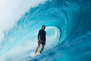 Surfer riding wave wearing Brickline performance Hybrid Shorts
