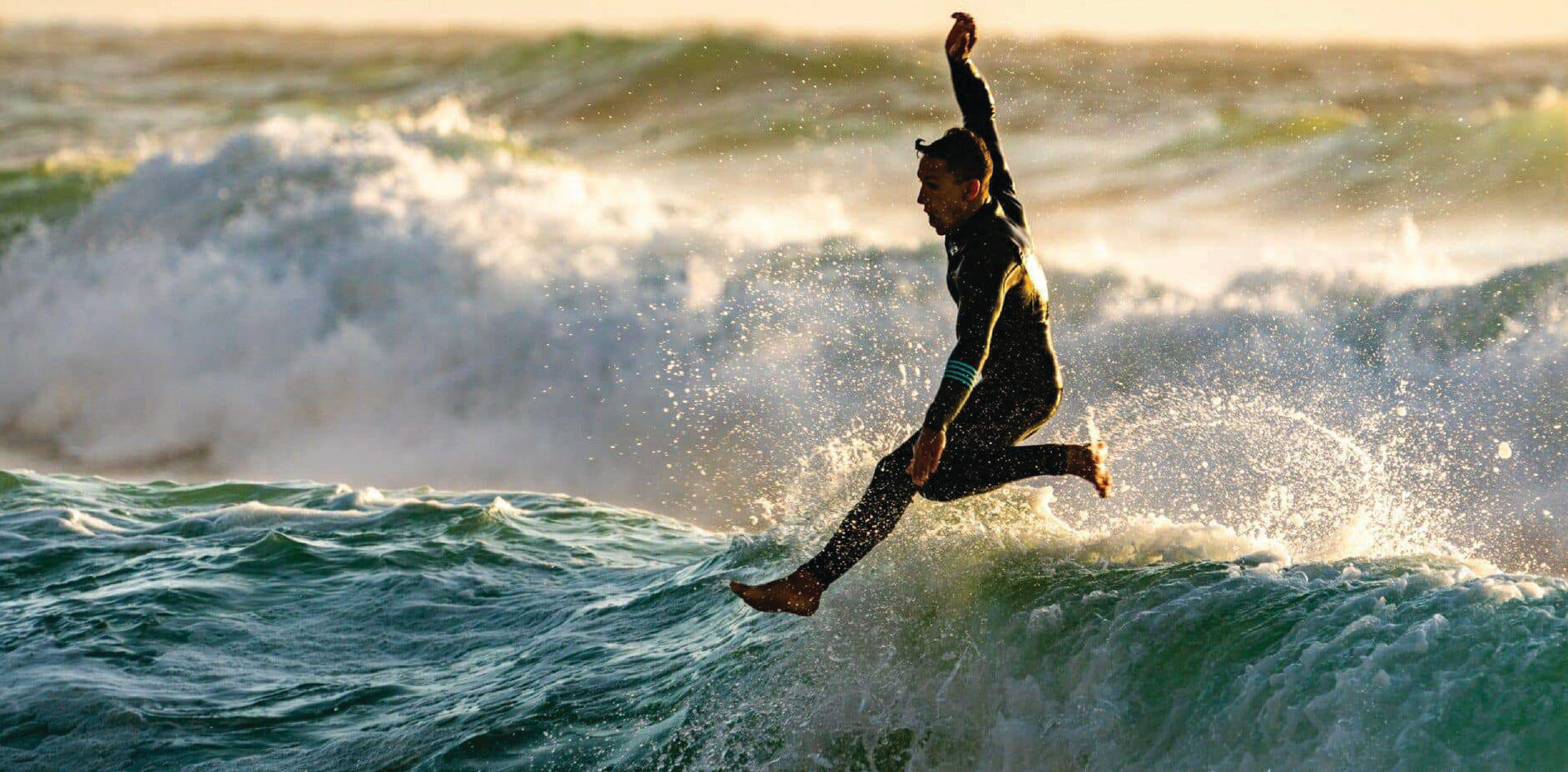 Surfer riding wave in Brickline performance swimwear