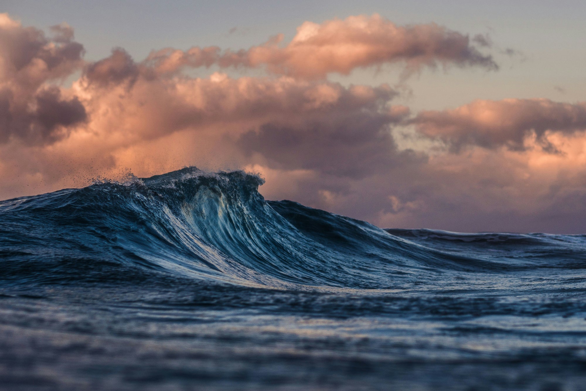 Athlete surfing in Brickline quick-dry Hybrid Shorts and rash guard, ocean sunset backdrop